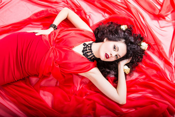 Obraz na płótnie Canvas caucasian girl with brunette hair on red dress