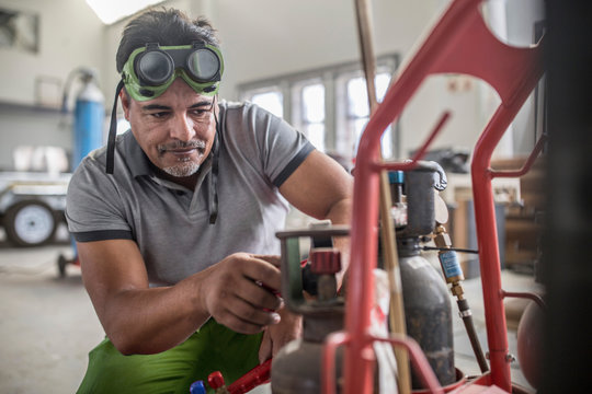 Man preparing welding jig in bodywork repair shop