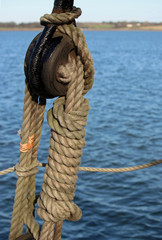 Fototapeta na wymiar Rope and pulley on sailing ship