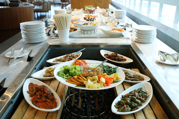 Healthy food on many dishes ready to serve by buffet style in restaurant