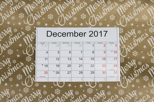 Calendar of the month December 2017 is on a festive golden background of "Merry Christmas". 