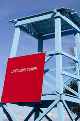 lifeguard tower blue at a beach on a greek beach with a sign on the side and copy space