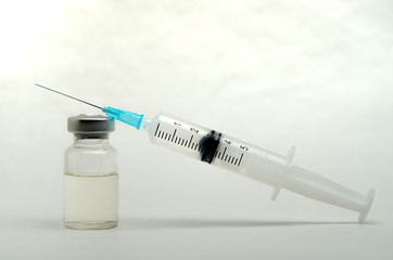 A medical syringe recruits a vaccine from an ampoule
