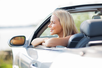 Fototapeta na wymiar happy young woman in convertible car