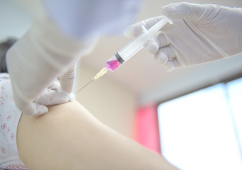 Soft focus nurses are vaccinations to patients using the syringe.Doctor vaccinating women in hospital.Are treated by the use of sterile injectable upper arm. injection