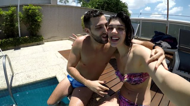 Young Couple taking a selfie in the Swimming Pool