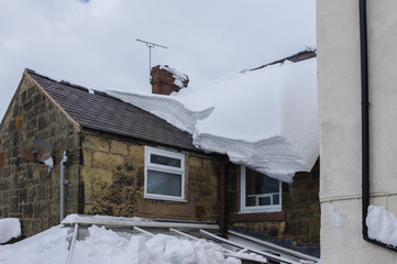 Thick snow on roof before falling through conservatory below.
