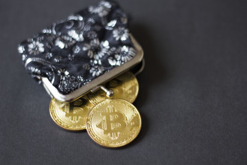 gold bitcoin wallet on a black background. the new virtual money