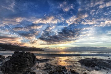 Fototapeta na wymiar Sunrise at Langland Bay on the Gower peninsula coast in Swansea, South Wales, UK
