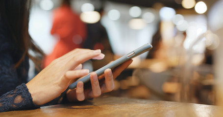Woman use of smart phone in coffee shop