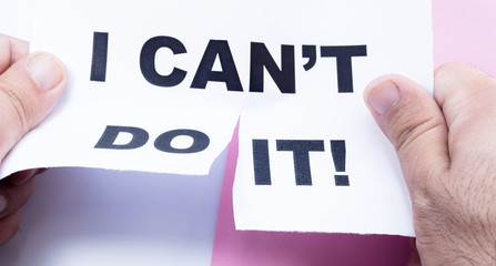 Hands tear paper with an inscription I can't do it.