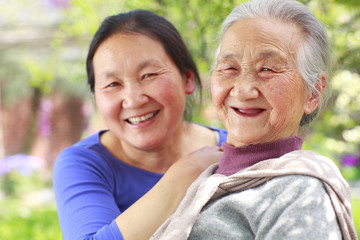 Obraz premium senior asian woman with her adult daughter outdoor in the yard happy lifestyles