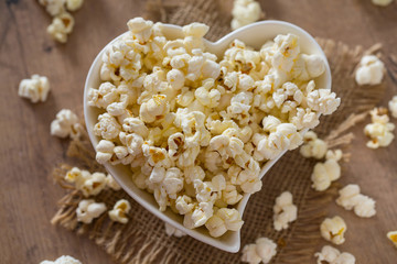 bowl of popcorn on wooden surface