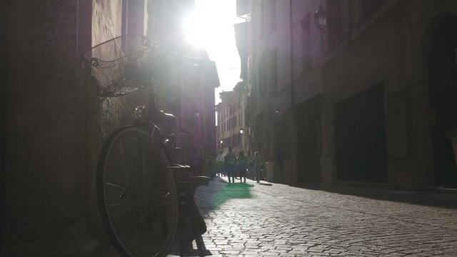 Salo, Italy. Summer, 2016. The sun shines brightly on to the narrow streets of Salo Italy as pedestrians walk by. Salo is a city of 10,000 located on the banks of Lake Garda.