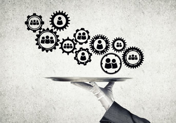 Waiter hand with white gloves holding silver plate full of social media communication icons