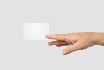 Obraz premium Mockup of female hand holding a Business Card isolated on light grey background. 
