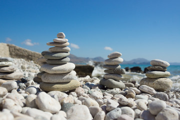 Pyramid of pebbles on a sea beach.