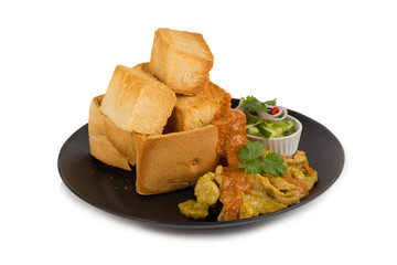 Pork satays with peanut sauce and pickles which are cucumber slices and onions in vinegar served with toast