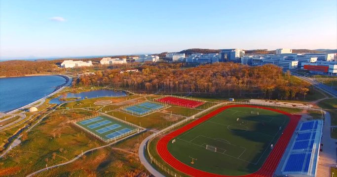 Campus of Far Eastern Federal University near Vladivostok. Sports ground, bay, pier and park. Aerial view