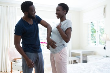 Man touching pregnant woman stomach