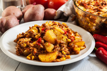 Portion of mexican potato casserole with minced meat