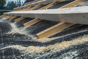 Roofers make the roof of a house in traditional construction