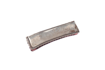 Old rusted harmonica isolated on white background