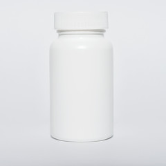 Small white vial with lid, isolated, close-up.
