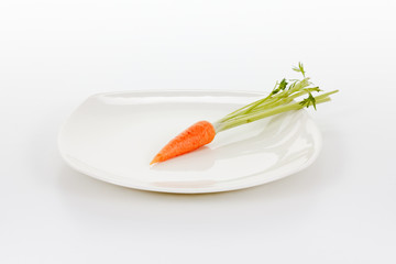 carrots with leaf on a white plate