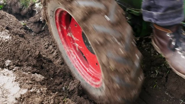 Detail of Small Tractor Ploughing a Field. Handheld Shot.