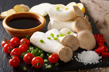 Raw King Brown Mushroom with ingredients for cooking close-up. Horizontal