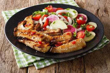 Fried spicy King Brown Mushroom with salad of radish and tomato close-up. horizontal