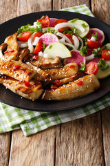 grilled French Horn Mushroom with sesame seeds and vegetable salad close-up. vertical
