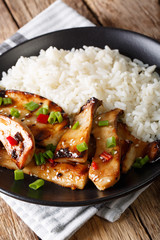 grilled Pleurotus eryngii mushrooms with rice and teriyaki sauce close-up. vertical