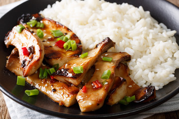 grilled king oyster mushrooms with rice and teriyaki sauce close-up. horizontal