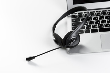 call center support concept. headset on keyboard computer laptop