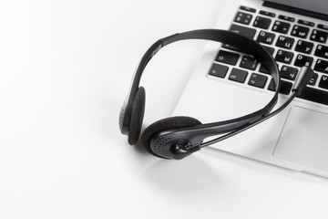 call center support concept. headset on keyboard computer laptop