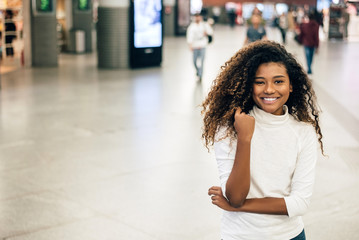 Portrait of smiling young woman at mall.
