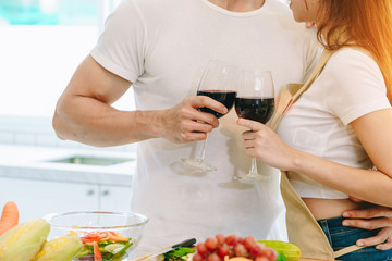 Asian teen couple are helping to make dinner. And bakery together happily. On Valentine's Day in their home.