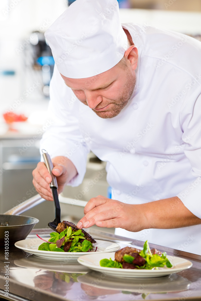 Wall mural chef prepares steak dish at gourmet restaurant