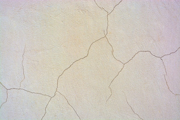 Background concrete wall, traces of weathering, the worn wall damaged paint old paint. Remnants of old paint on the painted concrete surface. A rough surface fracture.Tinted