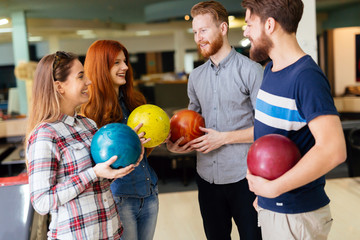 Fototapeta na wymiar Cheerful friends bowling together