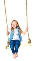 Little girl swinging on a swing