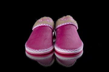 Female Pink Slipper on Black Background, isolated product, comfortable footwear.