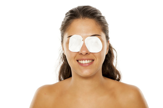 portrait of a young woman posing with cotton pads on her eyes