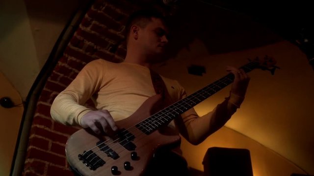 Rock musician plays solo on electric guitar. Man playing music on rock guitar