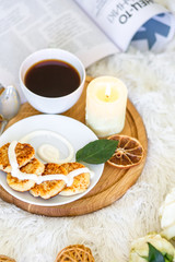 Breakfast. Lunch. Pancakes with cream. Candle and coffee. Cup of coffee with pankaces
