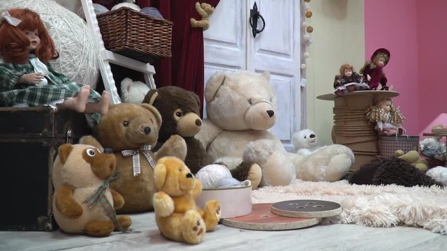 A cozy festive room with plush toys and dolls, slider shooting