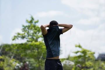 Soccer player standing with hand behind head © wavebreak3