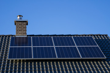 Closeup of photovoltaics on house roof for clean electrical energy - obrazy, fototapety, plakaty